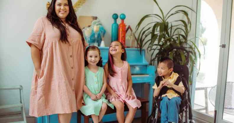 A photo of The McLeod Family consisting of mum Eeka McLeod and her three children Ella, Evan and Eli smiling at the camera or up at her