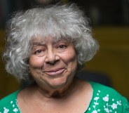 Miriam Margolyes standing in front of a yellow van