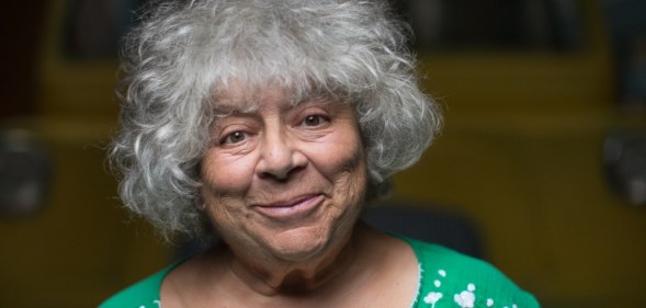 Miriam Margolyes standing in front of a yellow van