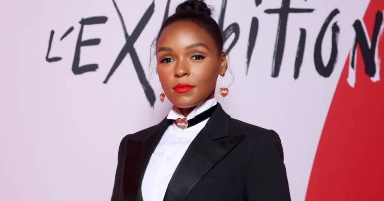 Janelle Monáe wears a black suit jacket, white shirt and collar