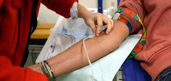 A person preps another individual to donate blood