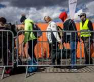 Refugees from Ukraine wait for the bus after they crossed the Ukrainian-Polish border at the border crossing in Medyka, southeastern Poland on April 8, 2022.