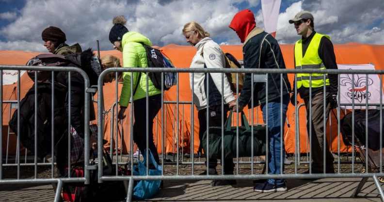 Refugees from Ukraine wait for the bus after they crossed the Ukrainian-Polish border at the border crossing in Medyka, southeastern Poland on April 8, 2022.