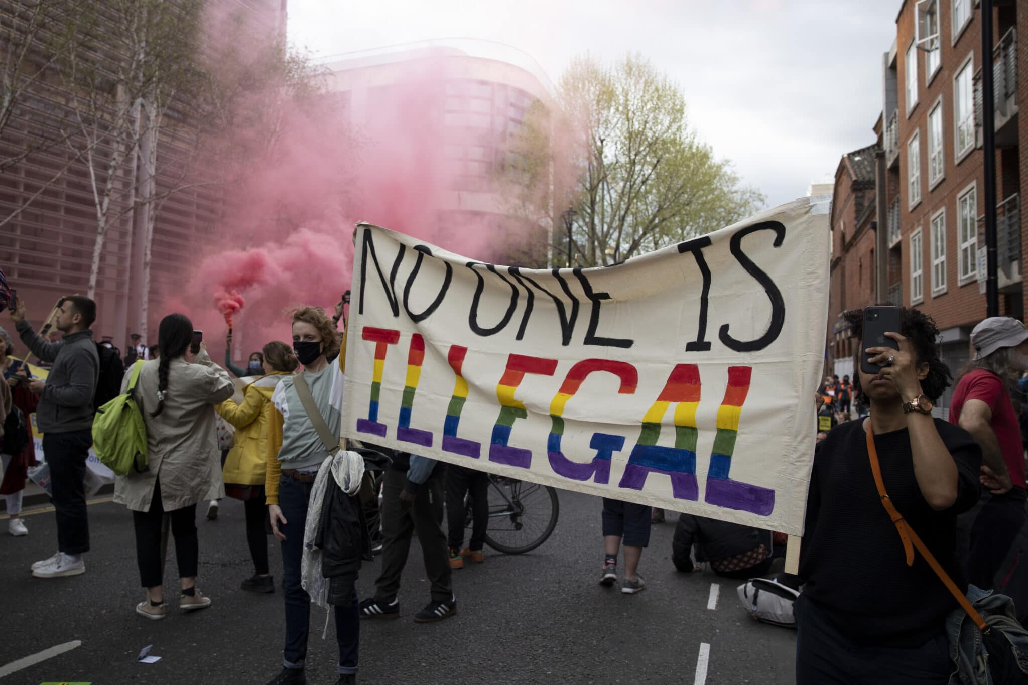 Protesters hold a banner during the demonstration against the Home Office