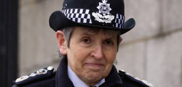 Outgoing Metropolitan Police commissioner Cressida Dick stares at the camera while wearing a black and white police uniform