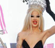 Willow Pill smiles and holds up their crown and sceptre as they are crowned the winner of Drag Race season 14