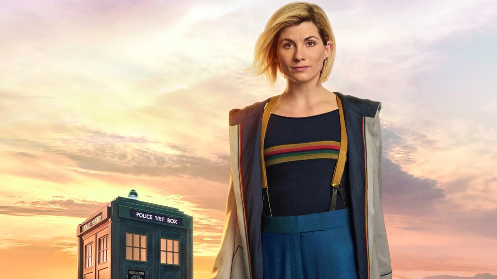 Jodie Whittaker as The Doctor, with a TARDIS in the background