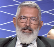 Paolo Rondelli, a white man with grey hair and a grey beard, wearing square metal glasses