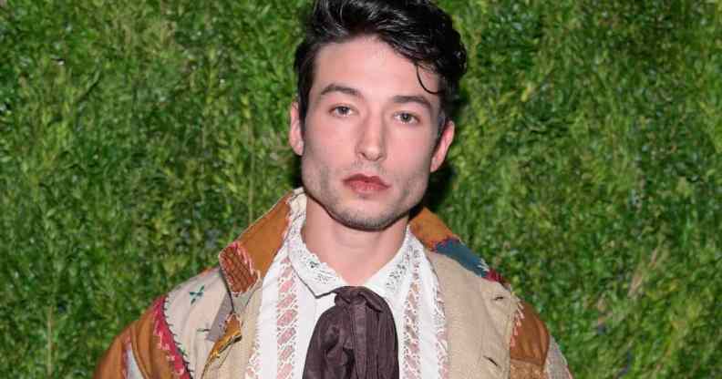 Actor Ezra Miller stares at the camera while wearing neutral coloured clothing