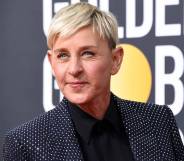 Ellen DeGeneres wears a black shirt, dark jacket which is decorated with rhinestones as she stares off camera