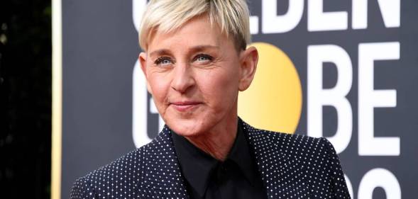 Ellen DeGeneres wears a black shirt, dark jacket which is decorated with rhinestones as she stares off camera