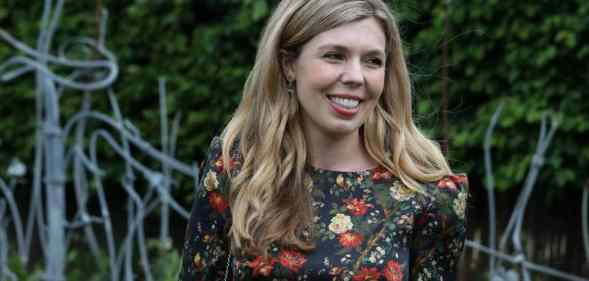 Carrie Johnson, the wife of prime minister Boris Johnson, wears a floral dress while standing outside