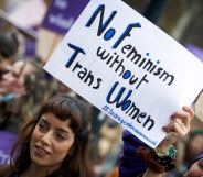 A protester holds a sign that reads: 'No feminism without trans women'