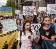 People hold banners and shout slogans during a demonstration in support of Mariupol defenders on May 3.