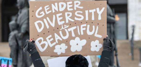 A person holds up a sign that reads "Gender Diversity is Beautiful" during a rally supporting trans youth