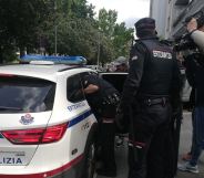 Nelson David MB is escorted to a police car by Basque police officers