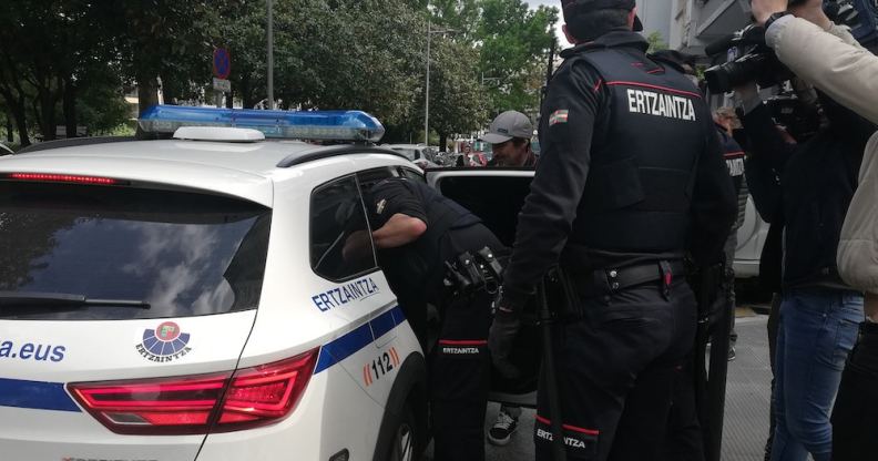 Nelson David MB is escorted to a police car by Basque police officers