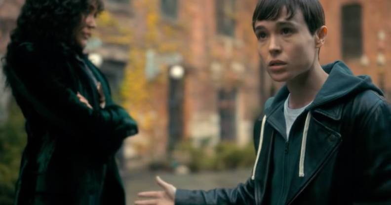 A screenshot from the trailer for Umbrella Academy season three in which Elliot Page's character Viktor talks to someone off screen and holds up their arm