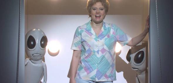 Kate McKinnon's character Colleen Rafferty bids farewell to Earth as she boards an alien spaceship on Saturday Night Live