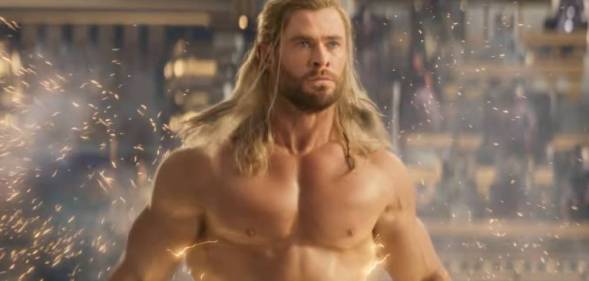 Chris Hemsworth as Marvel character Thor stands without a shirt as lightning trails behind him in the trailer for Thor: Love and Thunder