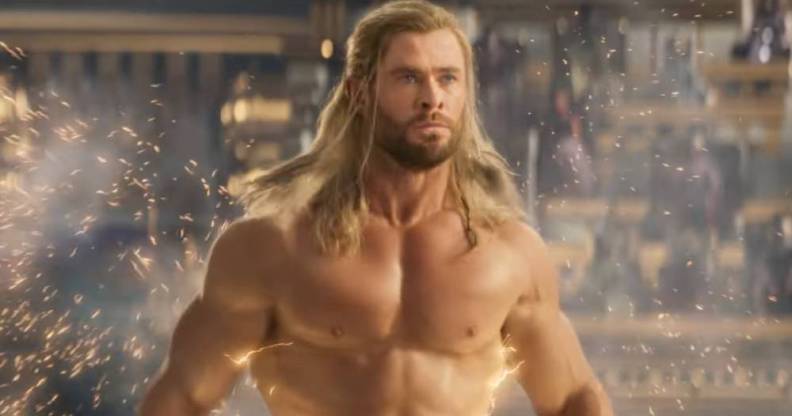 Chris Hemsworth as Marvel character Thor stands without a shirt as lightning trails behind him in the trailer for Thor: Love and Thunder