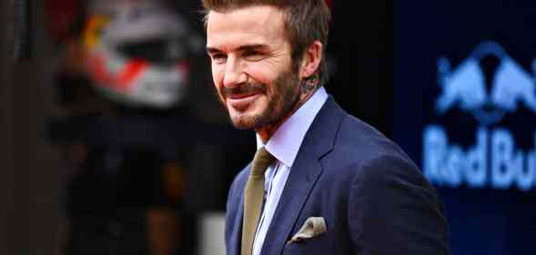 David Beckham wearing a suit, smiling