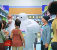 Baymax is surrounded by several people recommending period products