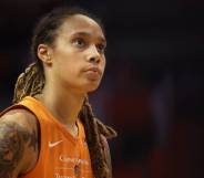 US basketball star Brittney Griner wears an orange jersey while looking up