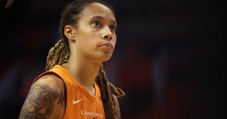 US basketball star Brittney Griner wears an orange jersey while looking up