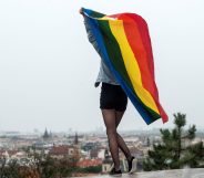 A participant waves a rainbow flag