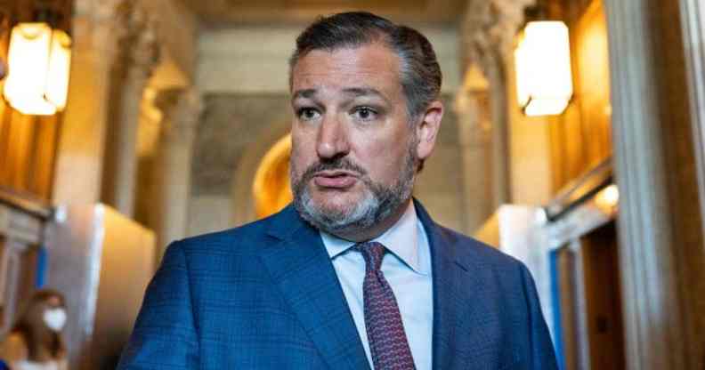 Ted Cruz wears a white button up shirt, red tie and blue suit jacket as he speaks with reporters in the Texas Capitol