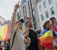 People walk through Oslo holding Pride flags