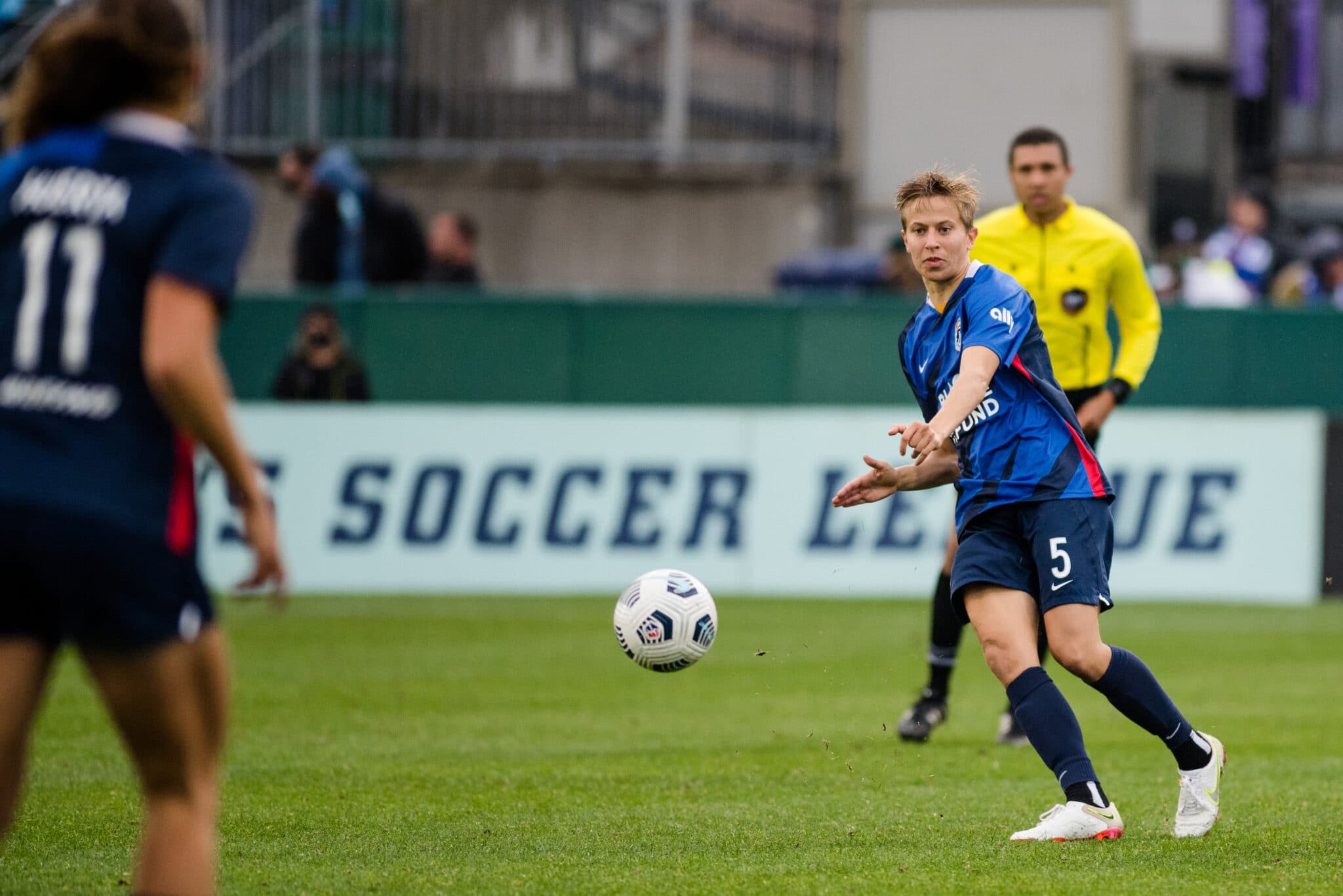 Quinn #5 of the OL Reign passes the ball during a game between Orlando Pride and OL Reign at Cheney Stadium on September 26, 2021 in Tacoma, 