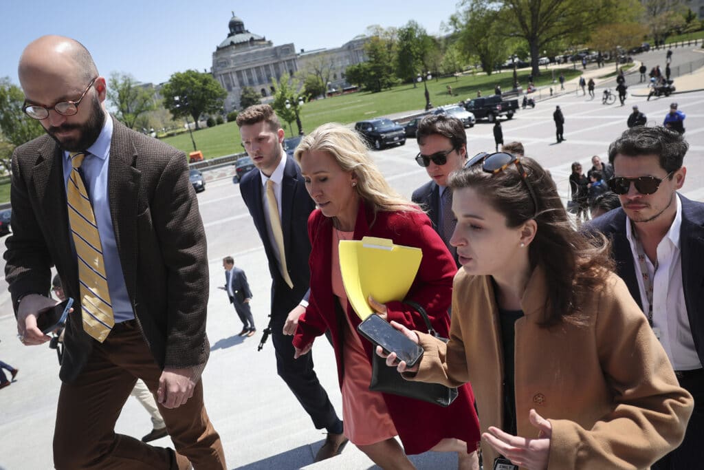 Milo Yiannopoulos (R) trails Rep. Marjorie Taylor Greene after she spoke at a press conference outside the US Capito