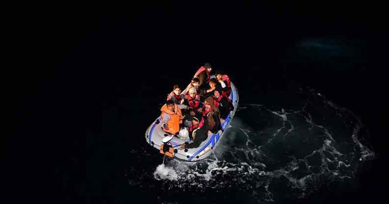 Turkish Coast Guard members intervene a boat carrying refugees, who were trying to go to Greek Islands, after being caught by the Turkish coast guards.