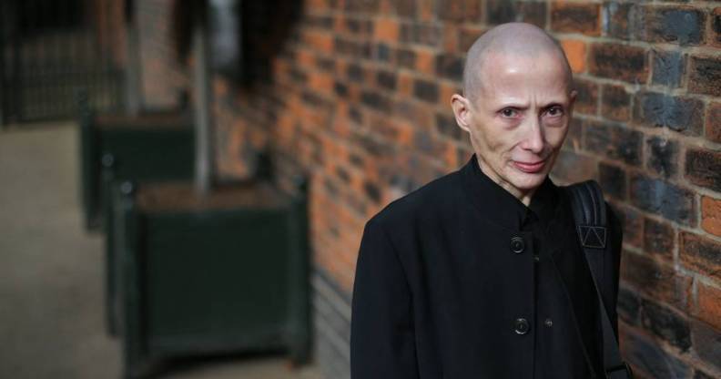 Non-gendered campaigner Christie Elan-Cane stands in front of a brick wall while wearing black clothing