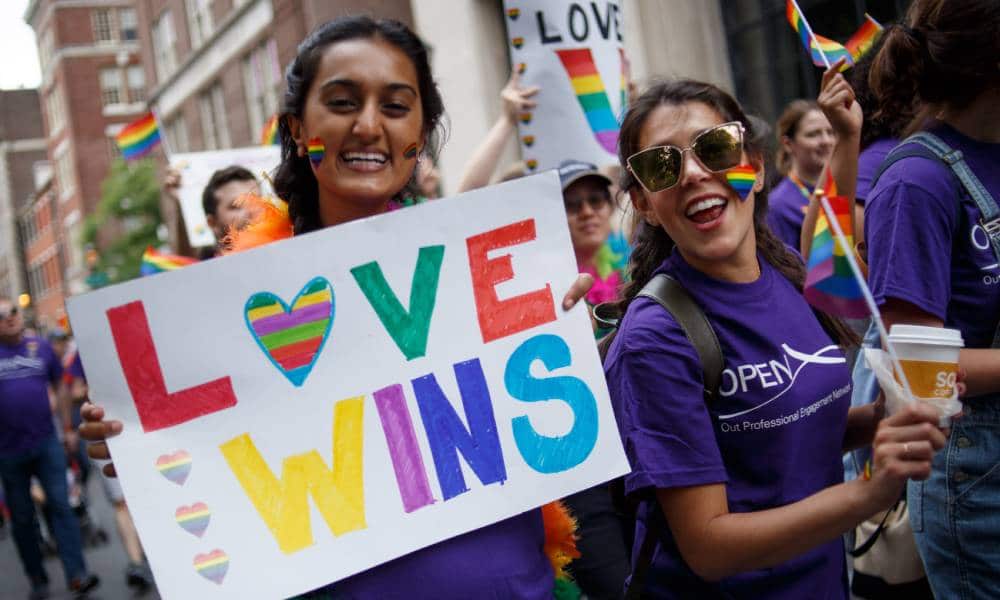 Revelers hold up a sign reading "Love wins" in rainbow coloured letters as they participate in the Philadelphia LGBT Pride Parade through the city's "Gayborhood" and downtown historic district in Pennsylvania