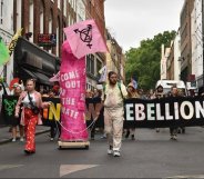 Rainbow Rebellion members march in Soho with a giant pink dildo