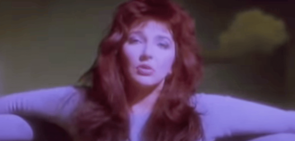 Kate Bush with red hair, in a lilac leotard