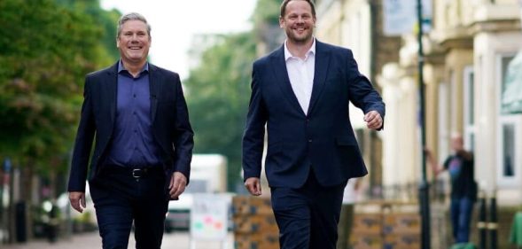 Labour leader Keir Starmer (L) and Simon Lightwood walking down a street