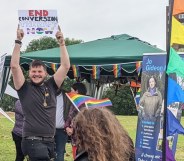 A student holding up a sign reading: 'End conversion therapy now'