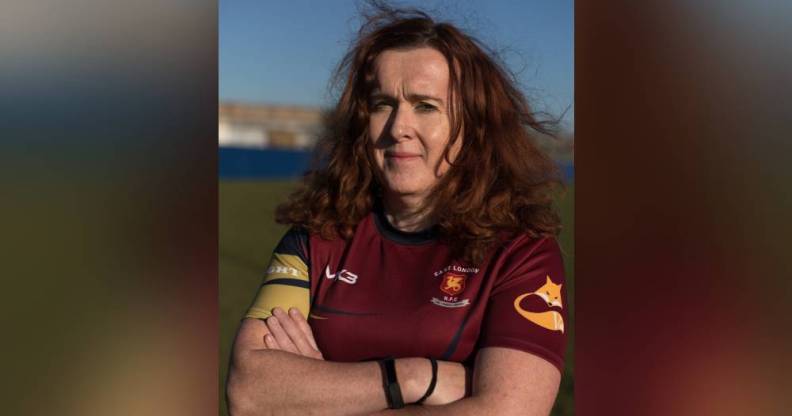 Alix Fitzgerald is seen wearing a red rugby jersey as she crosses her arms in front of her chest