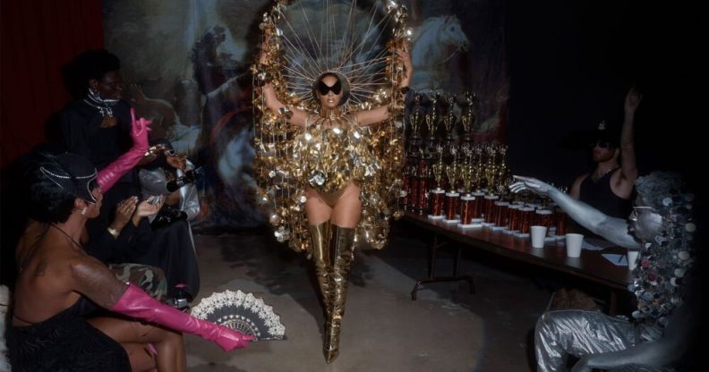 Beyoncé in a gold ballroom inspired outfit.