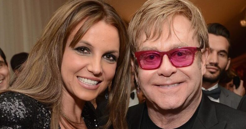 Britney Spears smiling next to Elton John