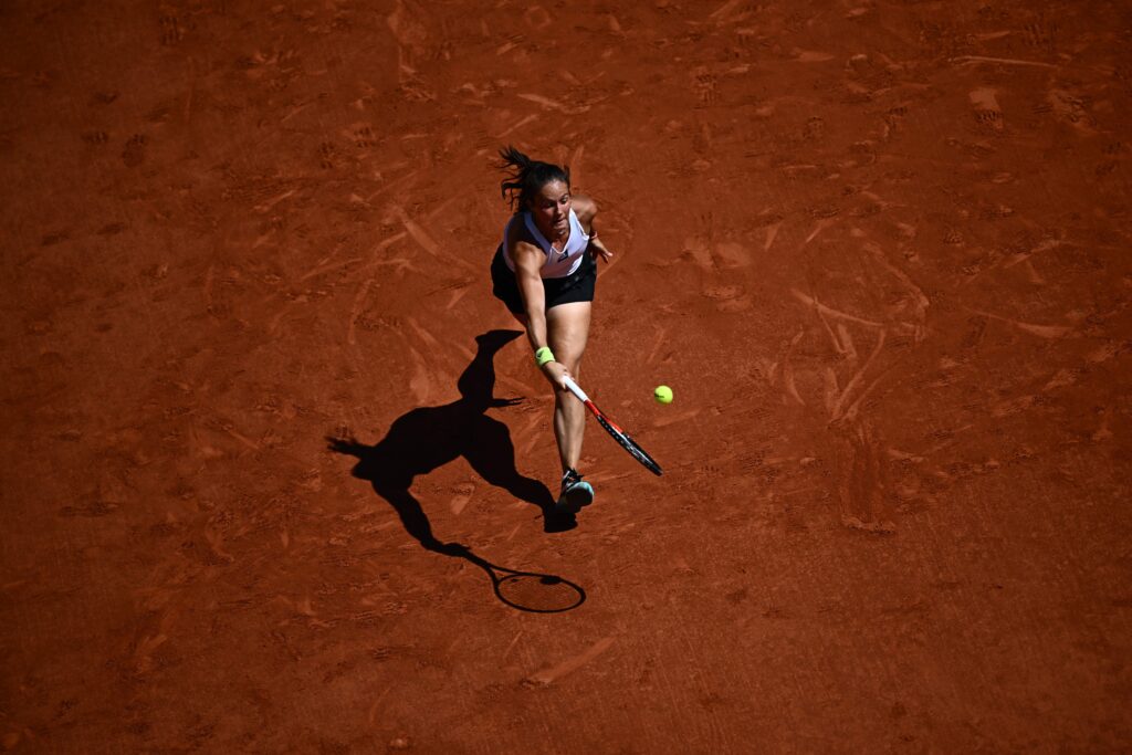 Daria Kasatkina returns the ball to Poland's Iga Swiatek