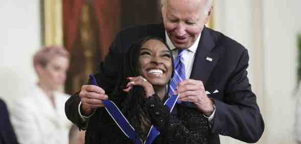 U.S. President Joe Biden presents the Presidential Medal of Freedom to Simone Biles, Olympic gold medal gymnast and mental health advocate, during a ceremony in the East Room of the White House July 7, 2022 in Washington, DC.