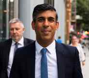 Rishi Sunak walks towards the camera in a suit