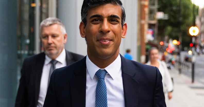 Rishi Sunak walks towards the camera in a suit