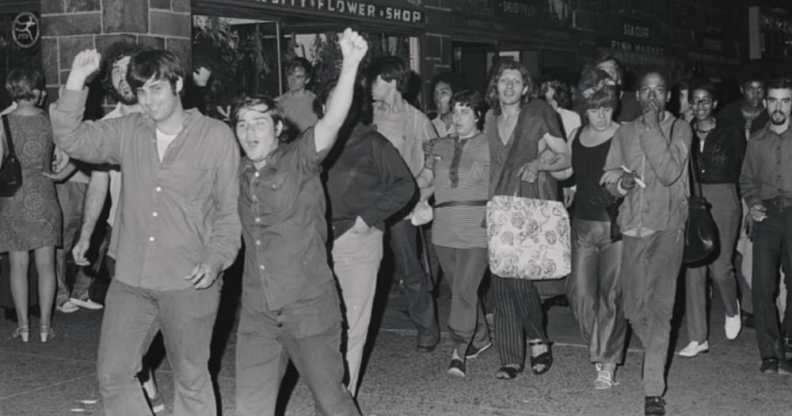 Mark at the Stonewall riots in 1969, pictured at the front with his arm raised.