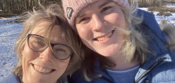 Alice Litman and her mum smiling, with snow visible on the ground behind them